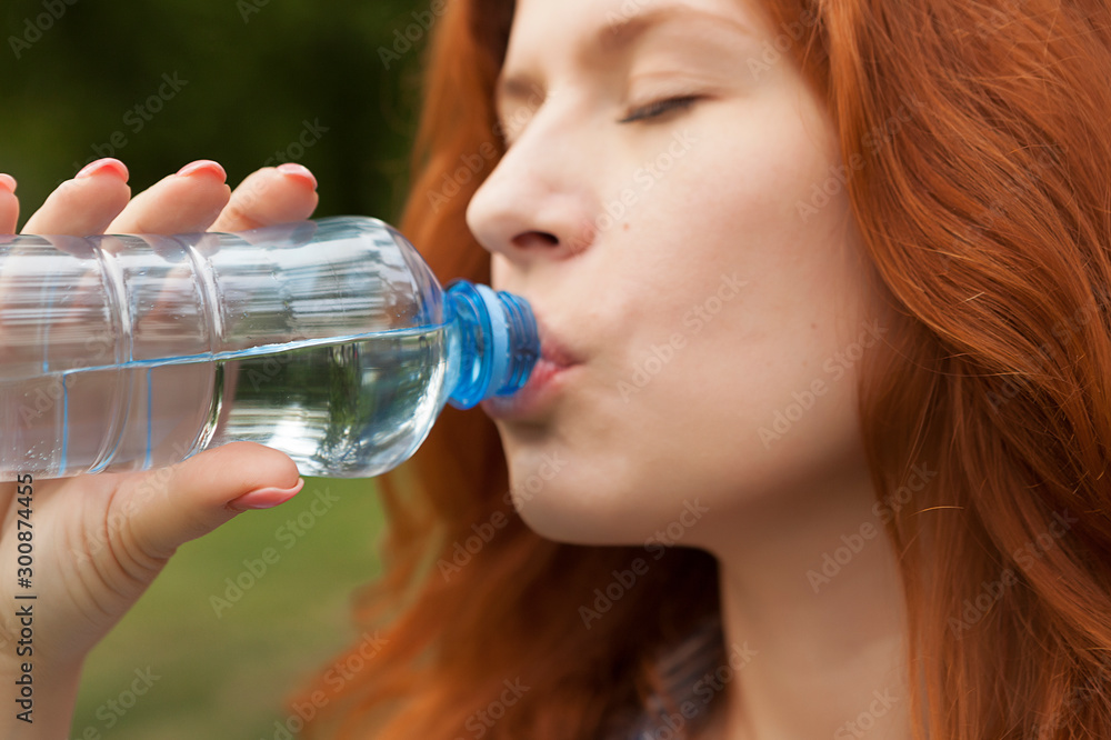 pure drinking water, young red-haired girl with a bottle of water, bottled water pure drinking water, young red-haired girl with a bottle of water, bottled water