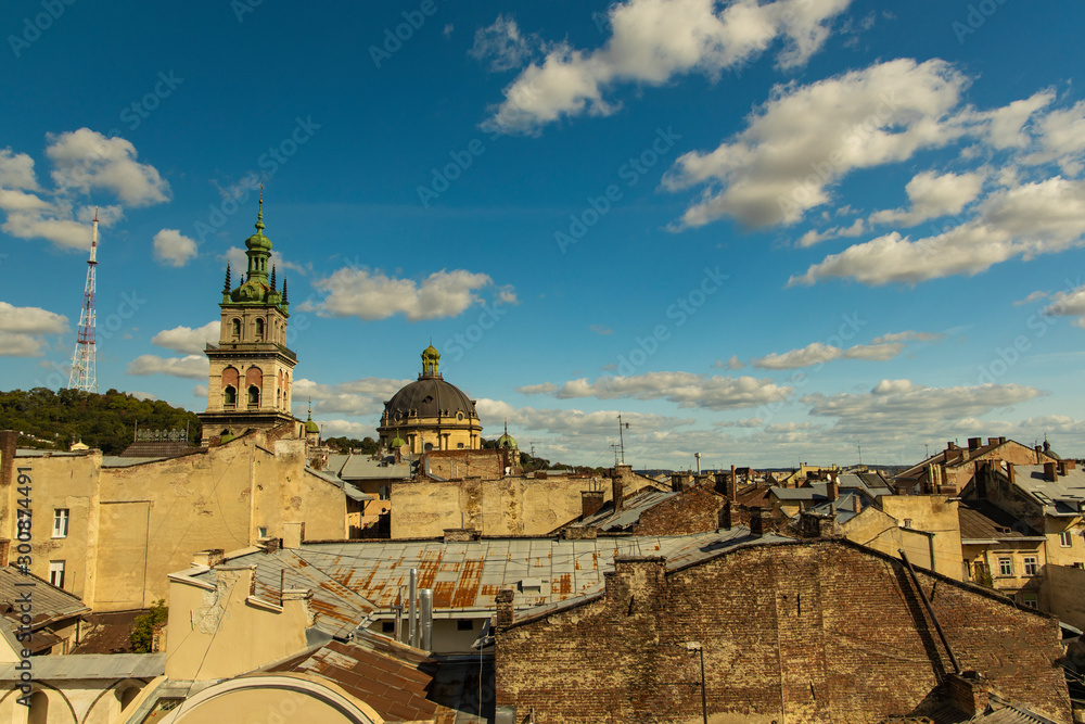 urban top view medieval city center Lviv in Ukraine with poor houses roofs cathedral dome and town hall tower touristic destination place in Eastern Europe 