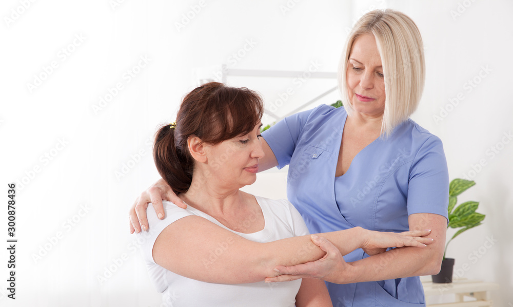Fototapeta premium Physiotherapy, sport injury rehabilitation treatment. Woman having chiropractic back adjustment. Osteopathy, Alternative medicine, pain relief concept.