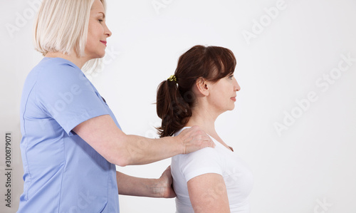 Female patient and doctor have consultation in hospital. Picture of middle aged woman during rehabilitation in professional clinic