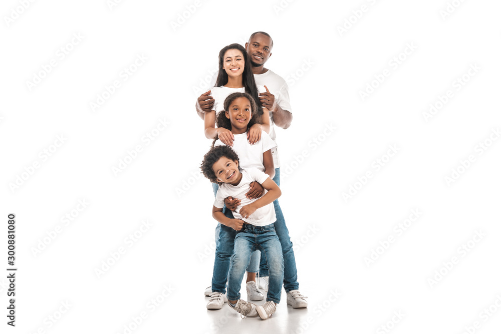 cheerful african american family standing one behind other and smiling at camera on white background