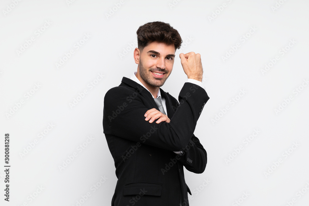 Young businessman over isolated white background making strong gesture Young businessman over isolated white background making strong gesture