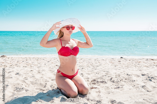 The sitting girl on the beach noticed © Haibullaev
