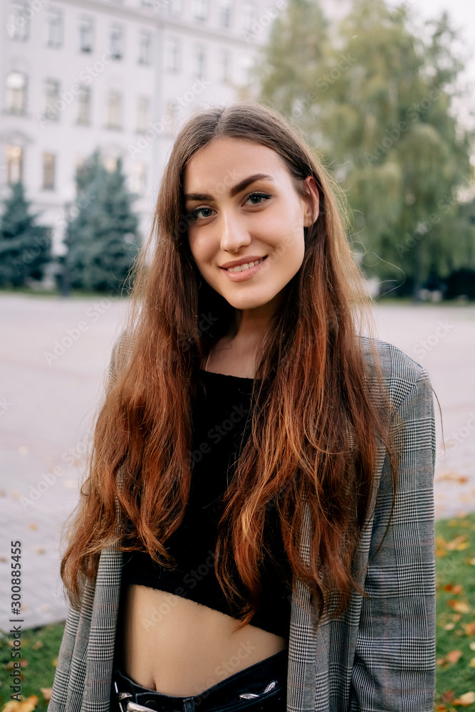 Outdoors portrait of beautiful young brunette girl. Outdoors portrait of beautiful young brunette girl.