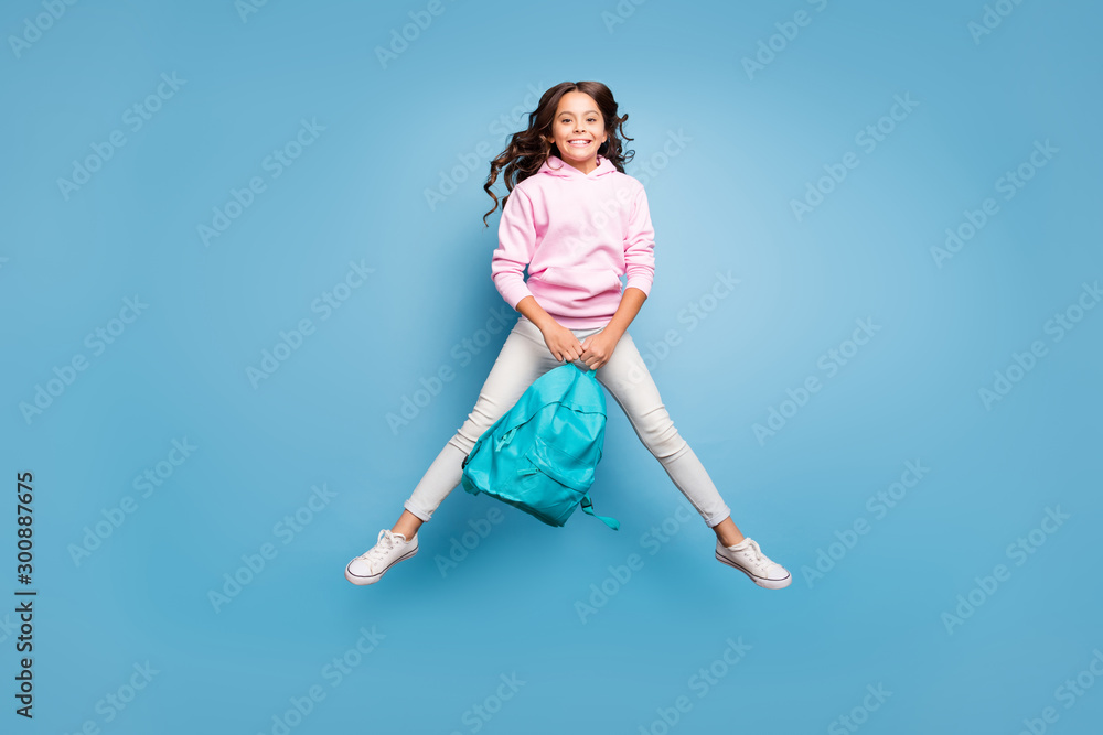Full length body size photo of cheerful trendy toothy beaming student holding backpack jumping up with weekends strarting isolated blue pastel color background Full length body size photo of cheerful trendy toothy beaming student holding backpack jumping up with weekends strarting isolated blue pastel color background