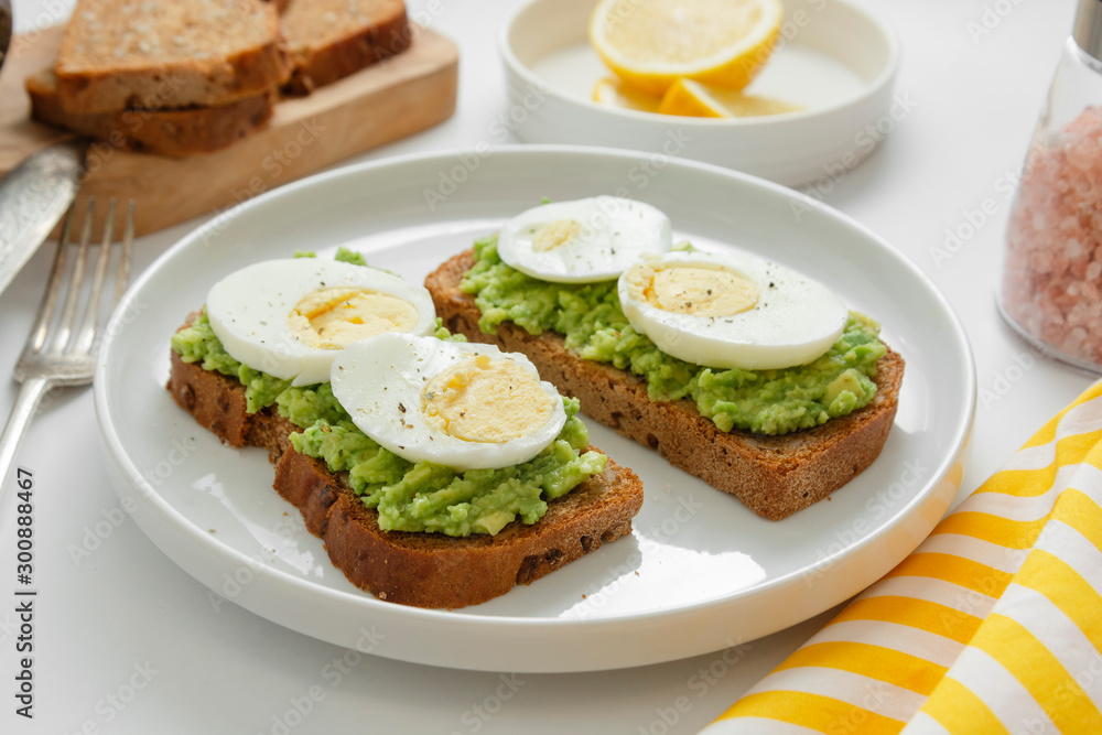 Avocado toast. Sandwich with egg, mashed on wholegrained bread. Healthy breakfast. Avocado toast. Sandwich with egg, mashed on wholegrained bread. Healthy breakfast.