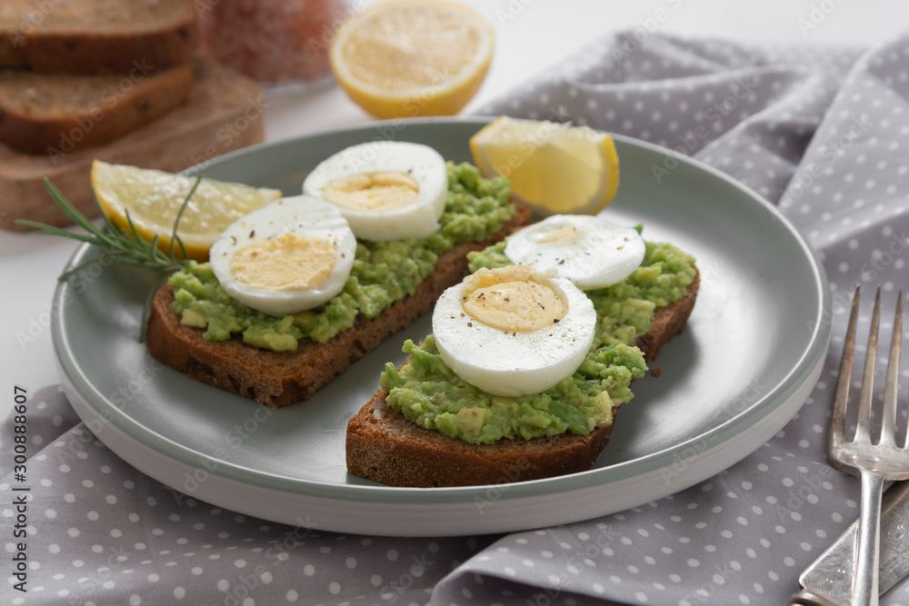 Avocado toast. Sandwich with egg, mashed on wholegrained bread. Healthy breakfast.