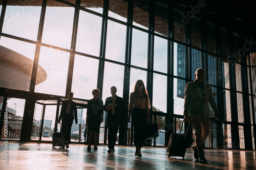 Group of business people walking in airport hall