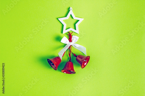 Christmas bells and other accessories on a green background. Save space