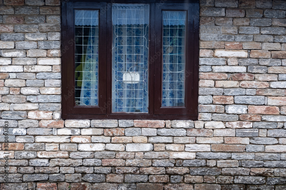 Modern window with skyscraper view in brick wall Modern window with skyscraper view in brick wall