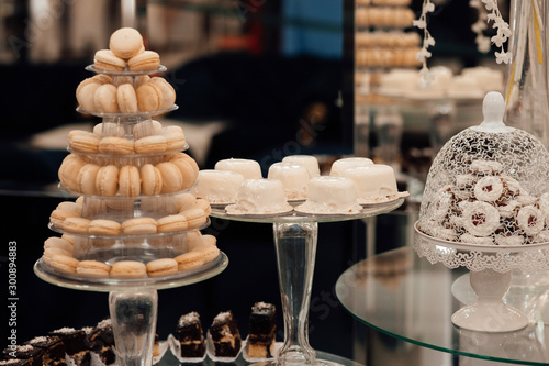 Candy bar for the wedding.Wedding decoration with pastel colored cupcakes, meringues, muffins and macarons. Elegant and luxurious event arrangement.  Luxury life.