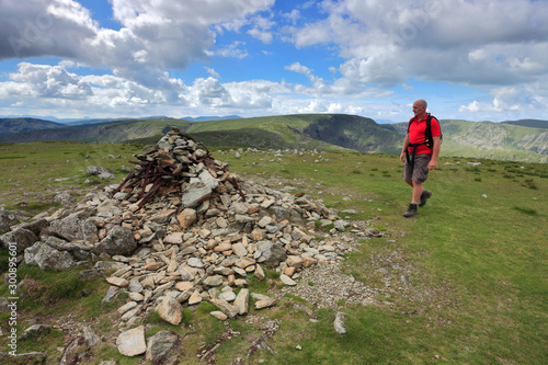 Walker, Summit cairn on Harter fell, Mardale Common, Lake District National Park, Cumbria County, England, UK photo