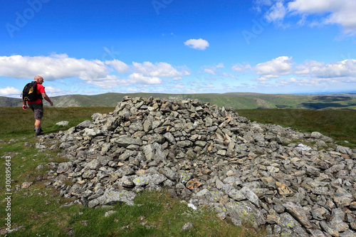 Walker, Summit cairn on Selside Fell, Mardale Common, Lake District National Park, Cumbria County, England, UK photo