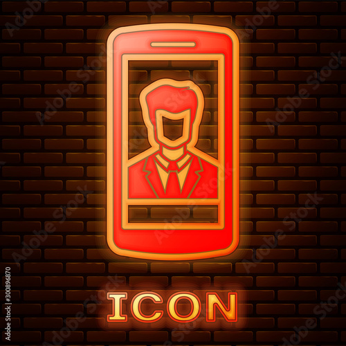 Glowing neon Smartphone with contact on screen icon isolated on brick wall background. Incoming call. Human on phone screen. Call contact. Vector Illustration