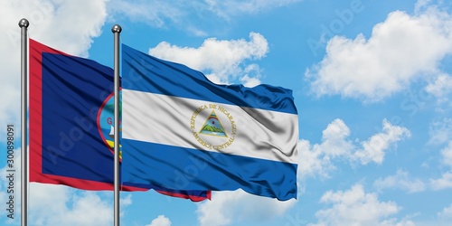 Guam and Nicaragua flag waving in the wind against white cloudy blue sky together. Diplomacy concept, international relations.