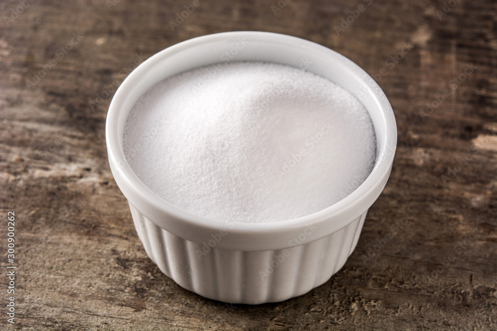 Baking soda in white bowl on wooden table. Baking soda in white bowl on wooden table.