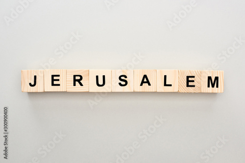 top view of wooden blocks with Jerusalem lettering on grey background