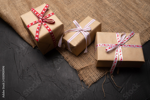 gift box with red ribbon and bow on wooden background