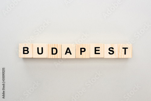 top view of wooden blocks with Budapest lettering on grey background