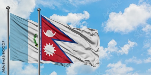 Guatemala and Nepal flag waving in the wind against white cloudy blue sky together. Diplomacy concept, international relations.