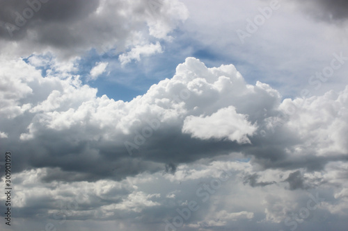 White and dark grey clouds on the blue sky