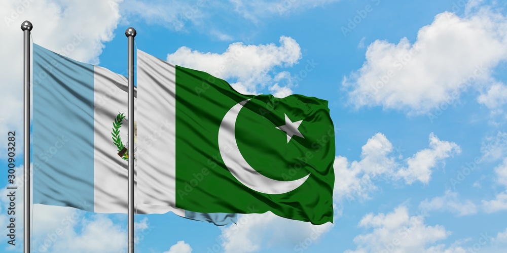 Guatemala and Pakistan flag waving in the wind against white cloudy blue sky together. Diplomacy concept, international relations. Guatemala and Pakistan flag waving in the wind against white cloudy blue sky together. Diplomacy concept, international relations.