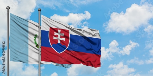 Guatemala and Slovakia flag waving in the wind against white cloudy blue sky together. Diplomacy concept, international relations.