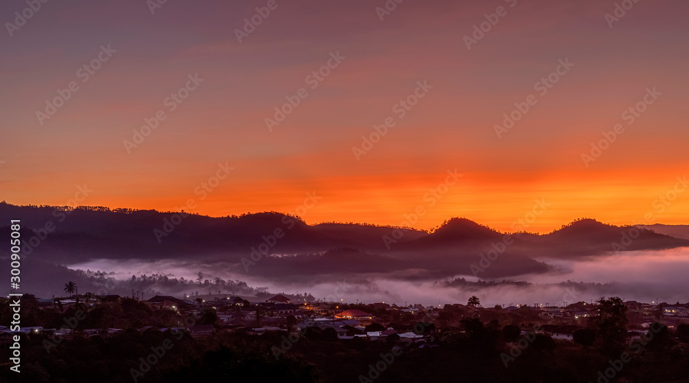 View of village covered in foggy during morning sunrise.