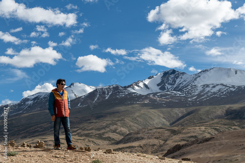 Traveler man enjoy at Tso Moriri Lake , Background is Snow top mountain,  Jammu and Kashmir, India