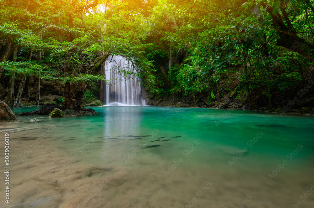 A beautiful waterfall deep in the tropical forest steep mountain adventure in the rainforest. - obrazy, fototapety, plakaty 