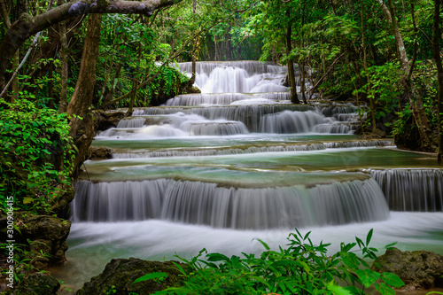 Fototapeta Naklejka Na Ścianę i Meble -  A beautiful waterfall deep in the tropical forest steep mountain adventure in the rainforest.