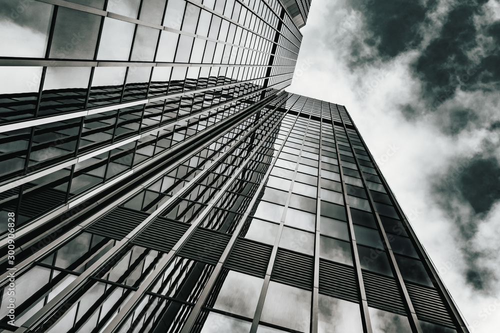Obraz premium Glass surface of skyscrapers view in district of business centers. black and white