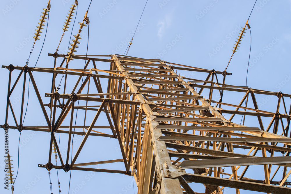 metal carcass of power electric transmission lines with wires insulators and wires at electrical substation with transformers metal carcass of power electric transmission lines with wires insulators and wires at electrical substation with transformers