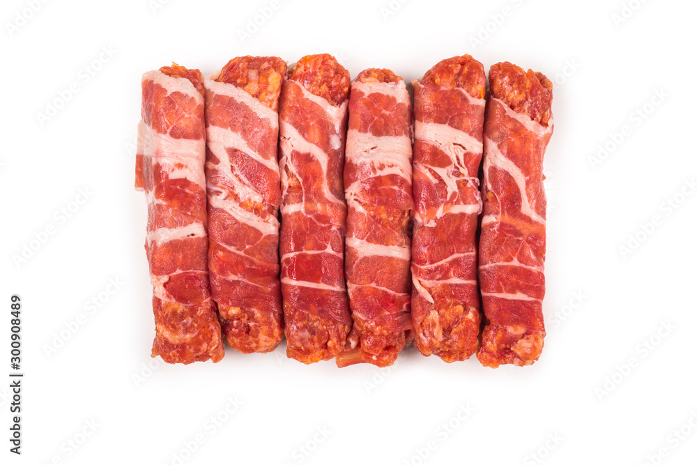 Chevapchichi in bacon isolated on white background. Chevapchichi in bacon isolated on white background.