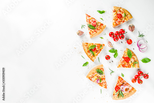 Pieces of cheese pizza Margarita with ingredients and herbs. White stone background top view