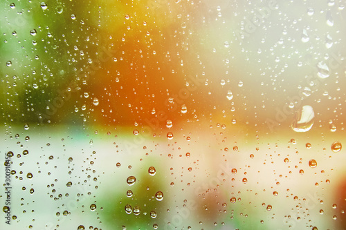 overlooking blur through the windshield of the car covered with rain for background