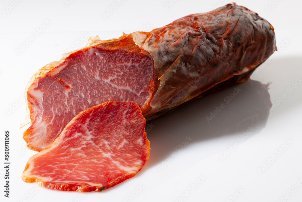 Fototapeta premium Lomo ibérico sobre fondo blanco. Iberian loin on white background