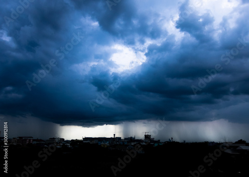 Storm cloud with heavy rain  lightning over city