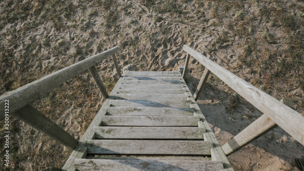 Steep wooden stairs heading down to the sand from the bird watching tower in Nida, Lithuania