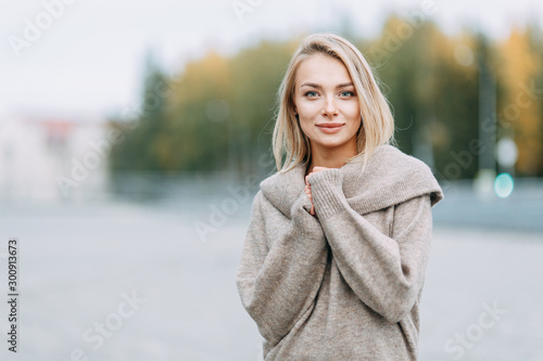 Business portrait on the background of the street. Beautiful girl with smile in town.