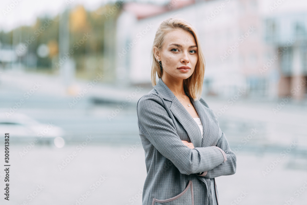 Business portrait on the background of the street. Beautiful girl with smile in town. Business portrait on the background of the street. Beautiful girl with smile in town.