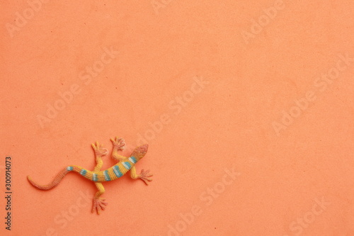 lizard shaped rubber toy in color background © robcartorres