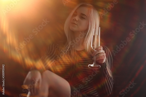 sexy blonde girl drinks champagne from a glass, evening glamorous style portrait