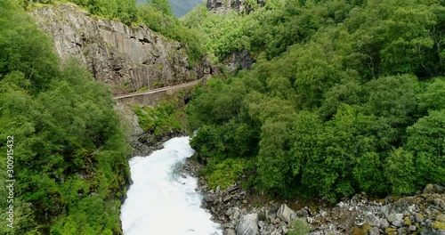 Train and Tracks Next to River in Valley, Slow Drone Shot photo