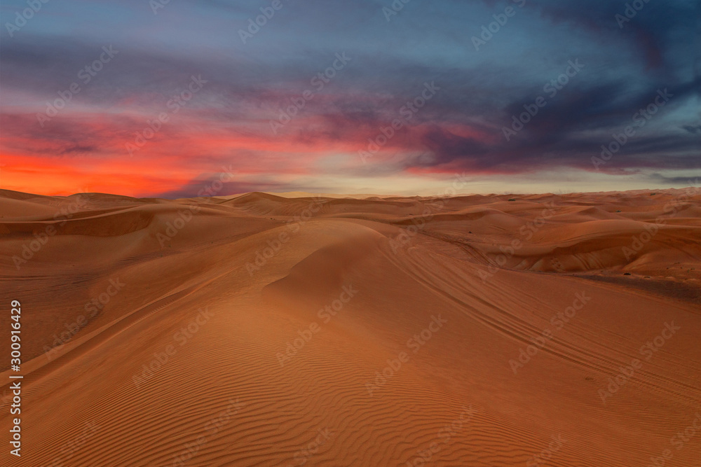 Sunset sky sand desert landscape, with dunes and red dramatic sunset picturesque view