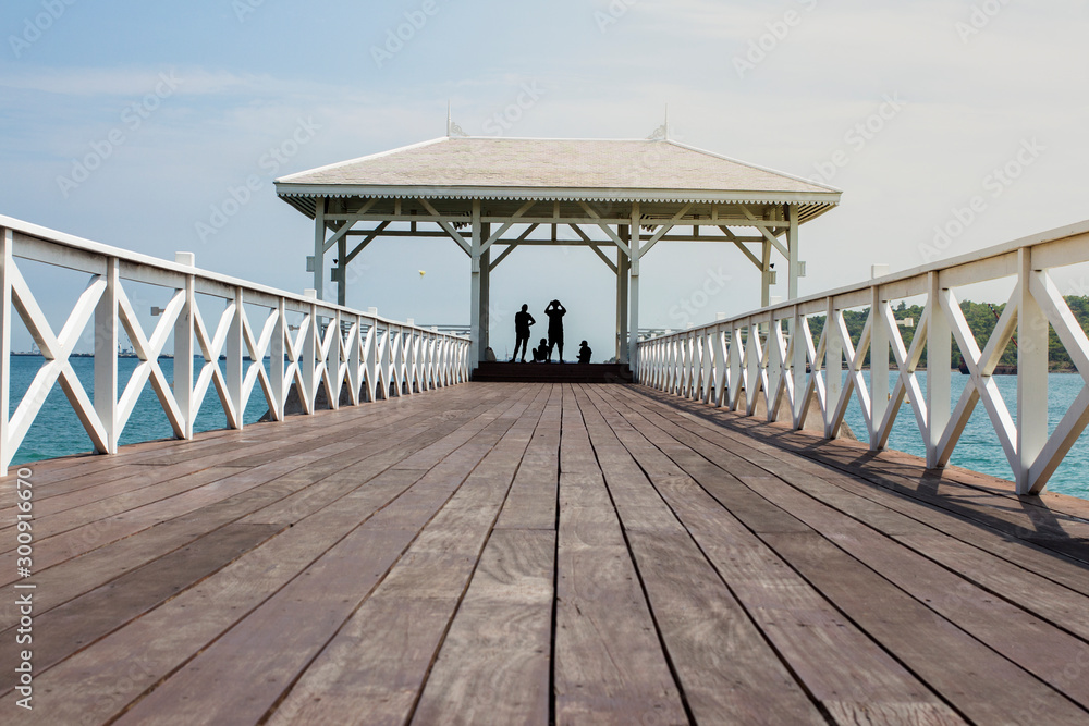 Asdang Bridge stretches out to the pavilion, with people standing and observing the view at Si Chang Island. Asdang Bridge stretches out to the pavilion, with people standing and observing the view at Si Chang Island.