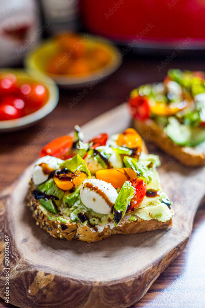 Toasts with Cherry Tomatoes, Mozzarella Cheese, Basil Leaves and Balsamic Sauce