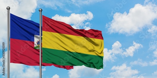 Φωτογραφία Haiti and Bolivia flag waving in the wind against white cloudy blue sky together