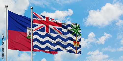 Fotografie Haiti and British Indian Ocean Territory flag waving in the wind against white cloudy blue sky together