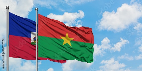 Εκτύπωση καμβά Haiti and Burkina Faso flag waving in the wind against white cloudy blue sky together